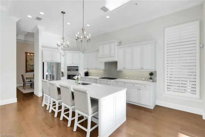 Kitchen featuring white cabinets, dishwasher, open floor plan, dark wood-style floors, and coffered ceiling