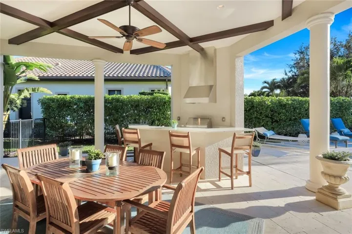 View of patio featuring outdoor dining space, an outdoor kitchen, ceiling fan, and an outdoor pool