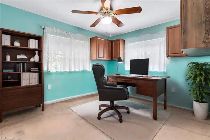 Virtually Staged Home office with a wealth of natural light and ceiling fan