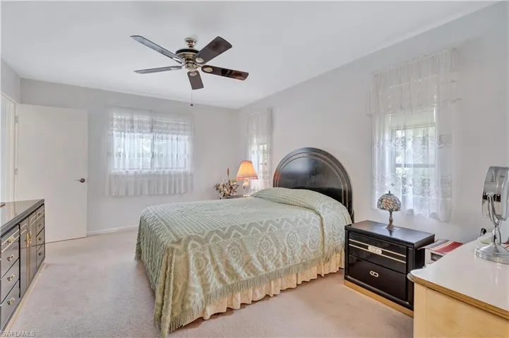 Carpeted bedroom with ceiling fan
