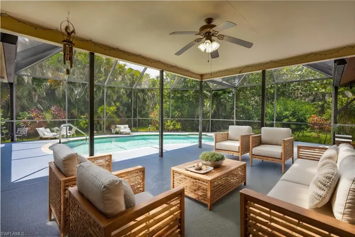 Virtually Staged Sunroom / solarium featuring plenty of natural light and ceiling fan