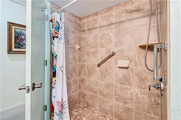 Bathroom featuring curtained shower