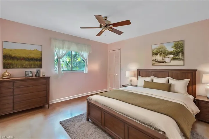 Virtually Staged Bedroom with hardwood / wood-style floors, ceiling fan, and a closet