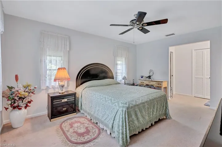 Bedroom featuring ceiling fan and light colored carpet