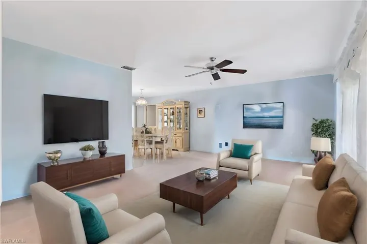 Virtually Staged Living room featuring ceiling fan