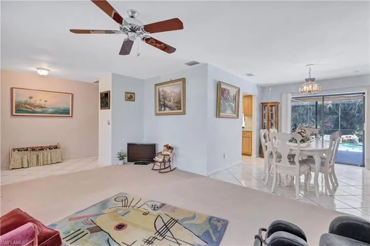 Living room with ceiling fan and light colored carpet