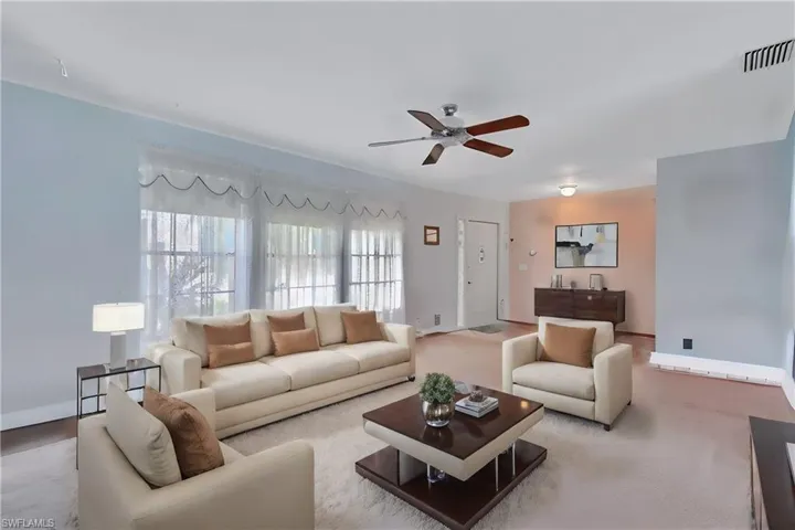 Virtually Staged Living room featuring carpet flooring and ceiling fan