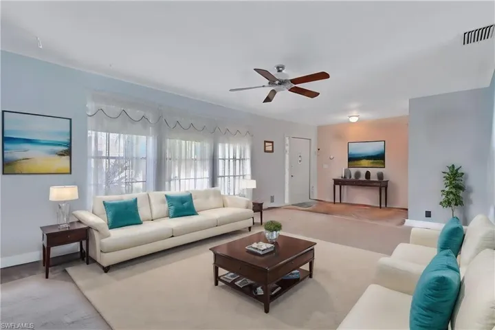 Virtually Staged Living room featuring ceiling fan and light carpet