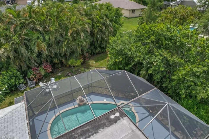View of pool with a jacuzzi and a lanai