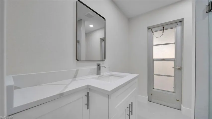 Bathroom with vanity and recessed lighting
