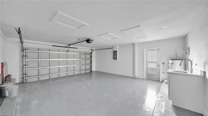 Garage with water heater and electric panel