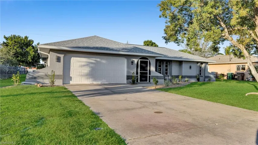 Single story home with stucco siding, a shingled roof, a front lawn, concrete driveway, and an attached garage