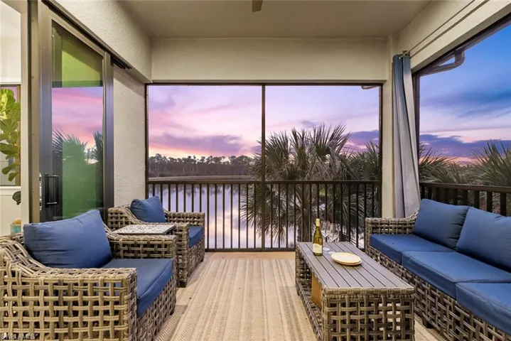 Sunroom featuring a water view