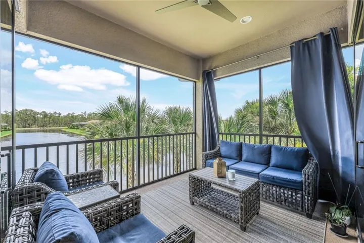Sunroom featuring a water view and ceiling fan