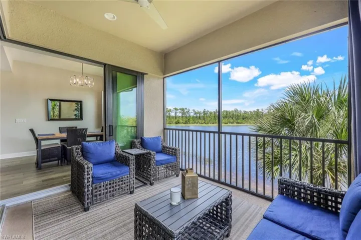 Sunroom / solarium with a water view and a notable chandelier