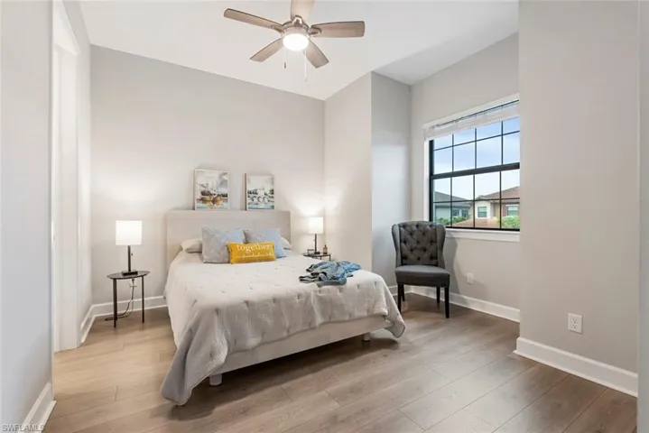 Bedroom featuring ceiling fan and wood-type flooring