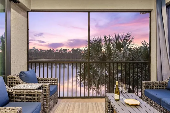 Sunroom / solarium featuring a water view