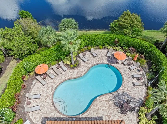 View of pool featuring a water view and a patio area