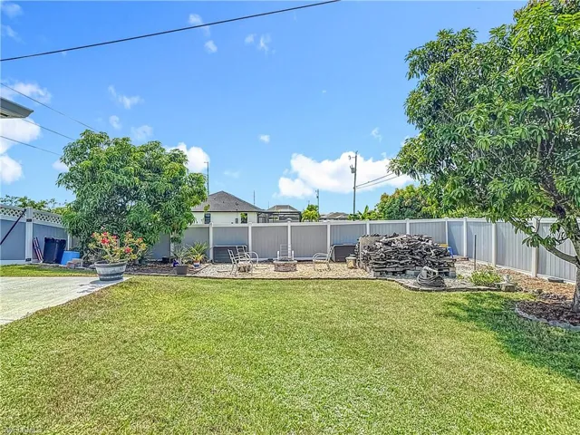Back yard with mango trees, pineapple plants and fire pit area with plenty of wood for relaxing evenings by the fire.