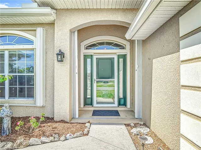 Notice accordion shutters, storm door and gutters to protect the entry.