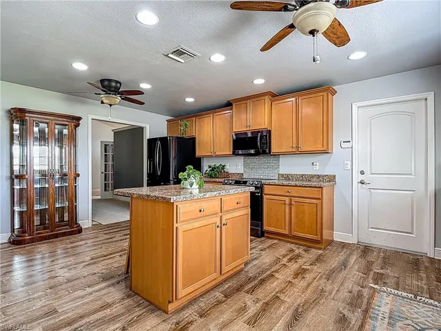 This is indeed, a chef's kitchen! Kitchen island with barstools for family & friends to gather while helping the chef!