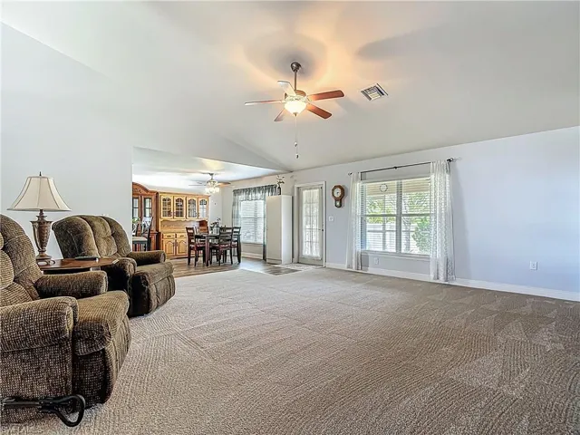 The living room and entire home is freshly painted!  The doorway leads to screened lanai overlooking the fenced back yard.