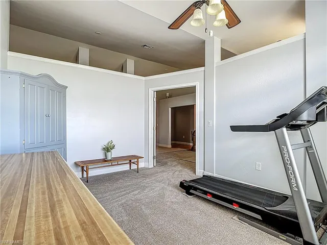 The multi-purpose den/office includes a corner cabinet for storage.