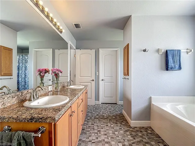 Large Ensuite bath with double sink vanity, soaking tub, separate shower & private toilet room.