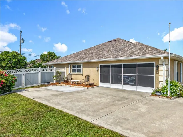 Side load garage on west side of house with seating area