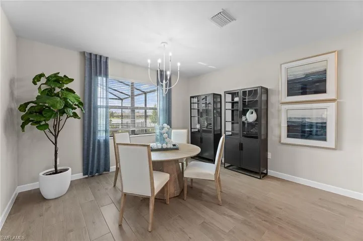 Dining area featuring light wood-style flooring and a chandelier