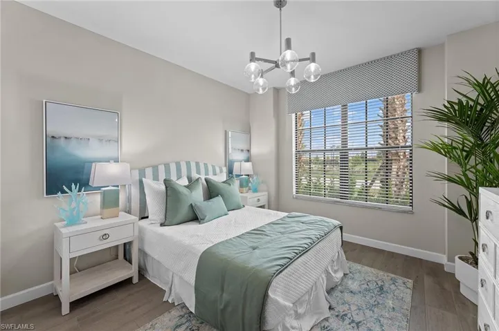 Bedroom featuring wood finished floors and suspended lighting