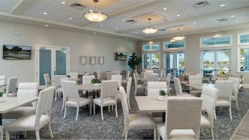 Dining area with french doors, a high ceiling, and recessed lighting