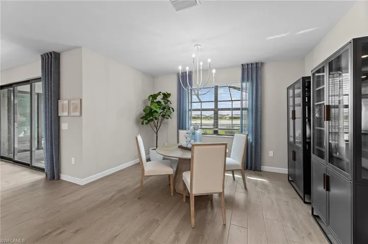 Dining area with a chandelier and light wood-style floors