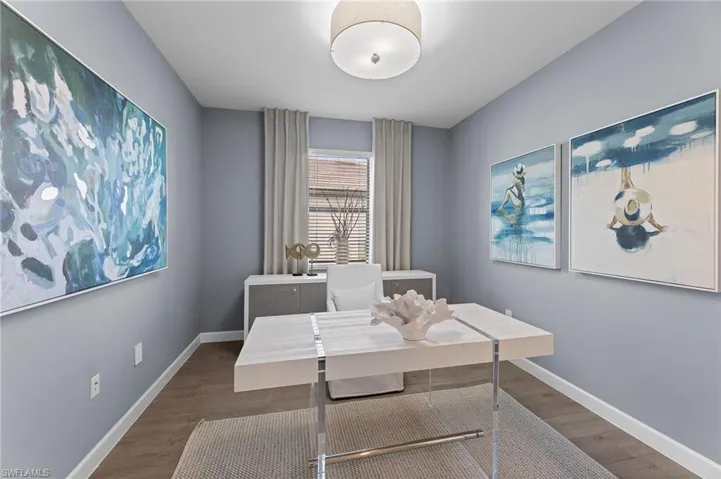 Home office with wood finished floors and baseboards