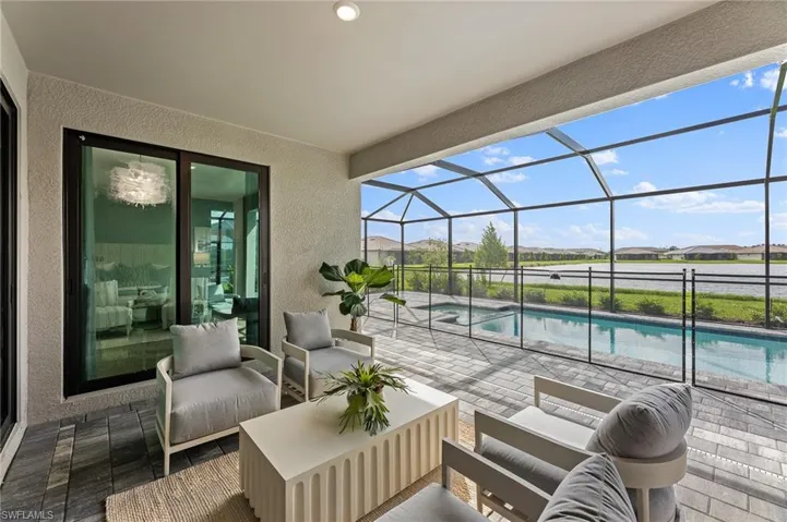 View of patio / terrace featuring outdoor lounge area, a sunroom, an outdoor pool, a residential view, and a lanai