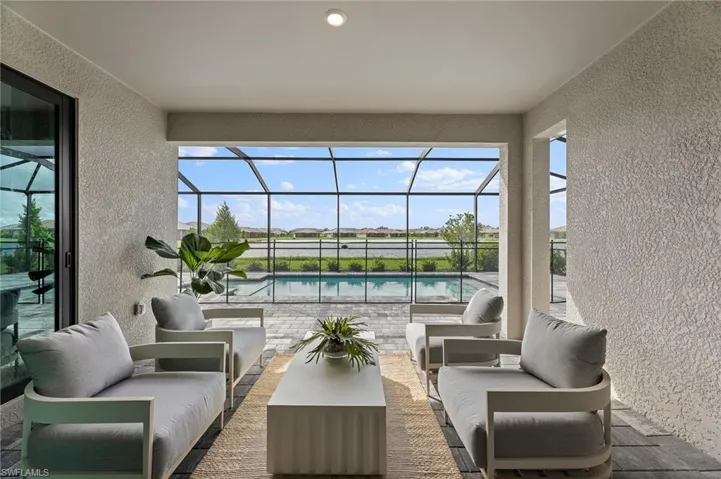 View of patio with outdoor lounge area, a sunroom, an outdoor pool, and a lanai