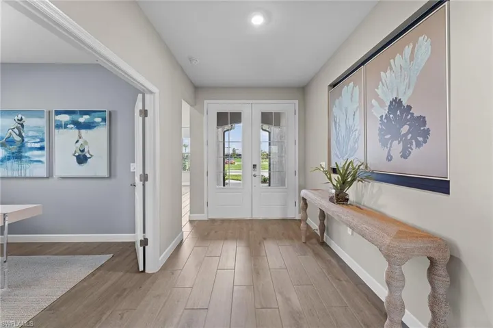 Foyer entrance with french doors and light wood finished floors