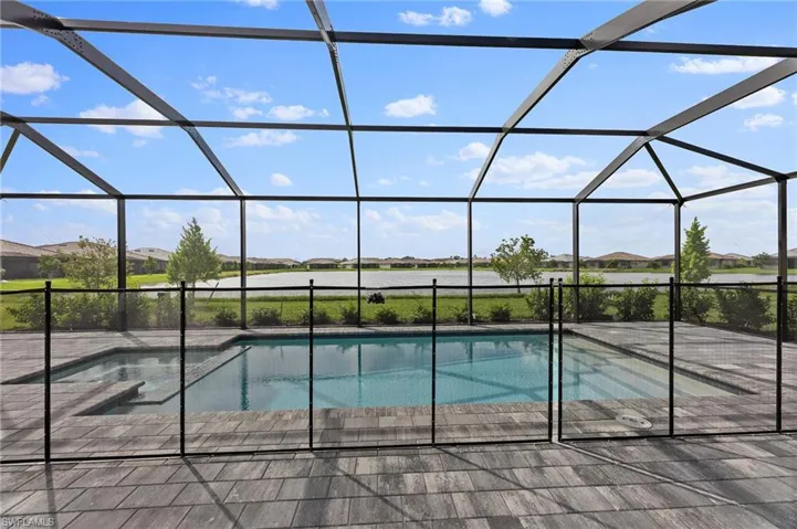 Swimming pool with a residential view, a sunroom, and a lanai