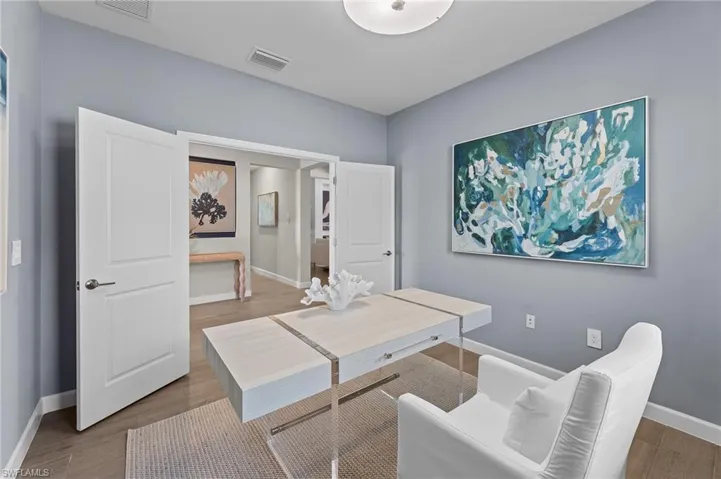 Home office featuring baseboards and wood finished floors