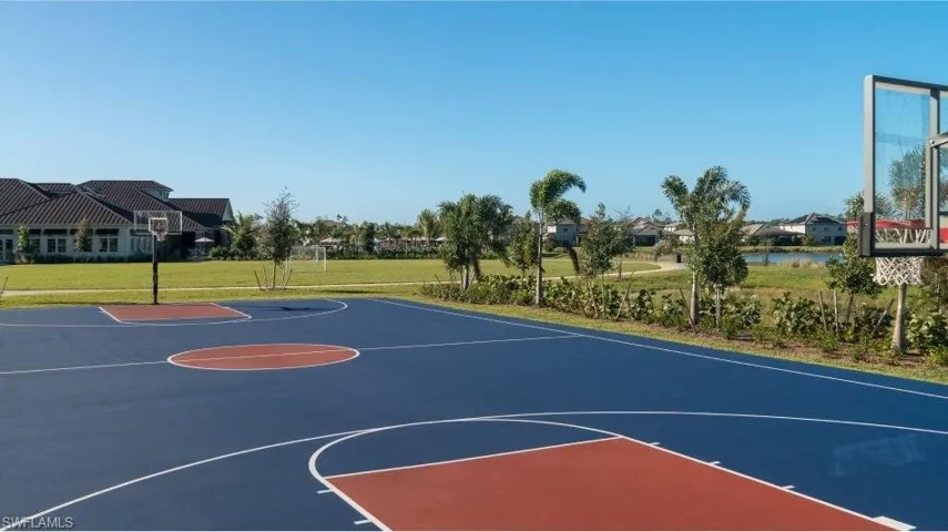 View of basketball court featuring community basketball court and a lawn