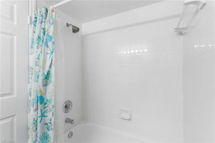 Full bathroom featuring shower / bathtub combination with curtain