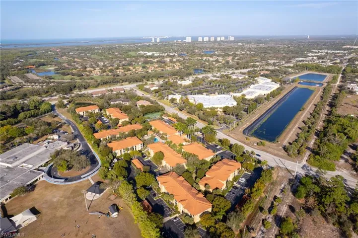 Aerial view of property and surrounding area featuring a large body of water
