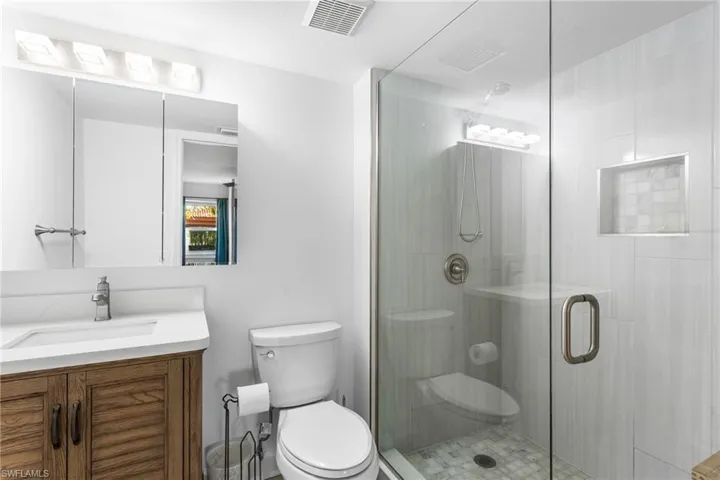 Full bath with vanity and a shower stall