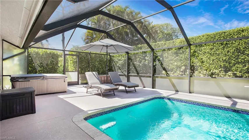 Pool featuring a lanai, a hot tub, and a patio