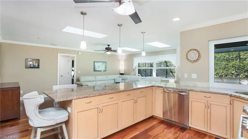 Kitchen with a healthy amount of sunlight which features a large breakfast bar area