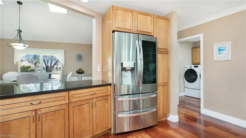 Kitchen featuring open pass through for serving your guests in the dining room, Clear View French Door stainless steel refrigerator with ice and water dispenser
