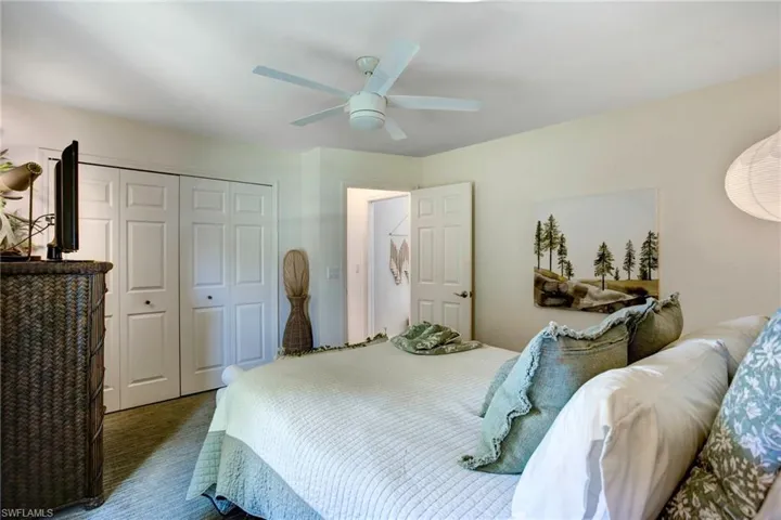 Carpeted bedroom with a closet and ceiling fan