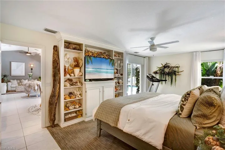 Bedroom with access to outside, tile floors, and ceiling fan