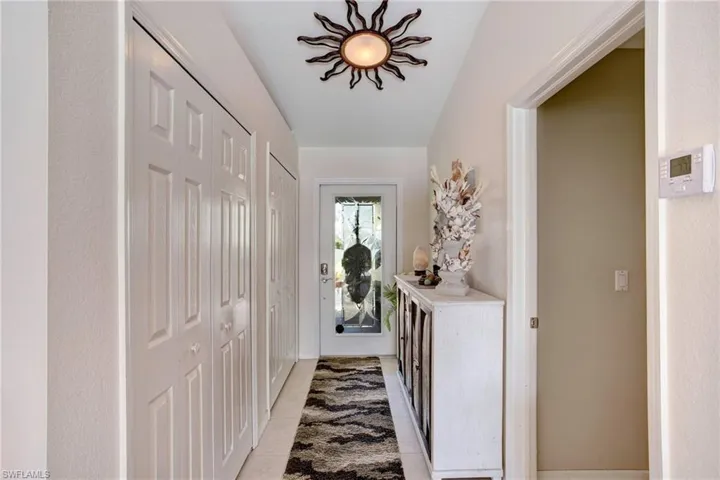 Doorway to outside with light tile floors