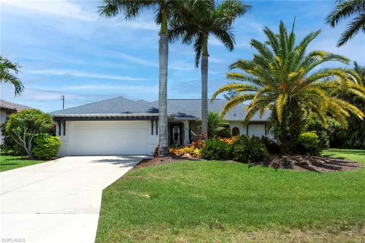 Ranch-style home featuring a garage and a front yard